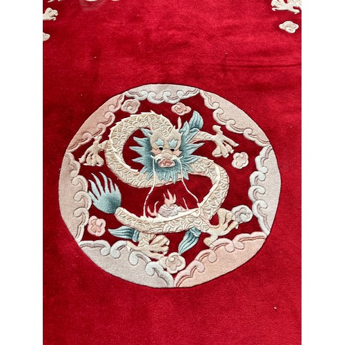 129 - A Chinese dragon pattern rug - approx. 280cm x 183cm