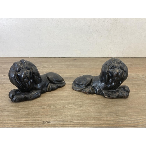 419 - A pair of cast iron and black painted doorstops in the form of lions