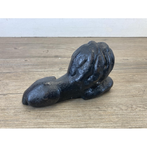 419 - A pair of cast iron and black painted doorstops in the form of lions