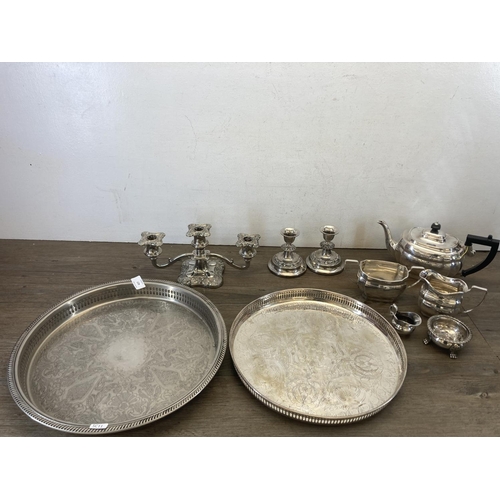 427 - Ten pieces of silver plated ware to include Unett plate three piece tea set, two branch candelabra, ... 