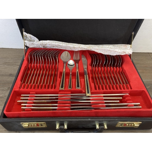 452 - A Mulex Edel Stahl Rostfrei 18/10 stainless steel and gilt two tier cutlery set in leather case with... 