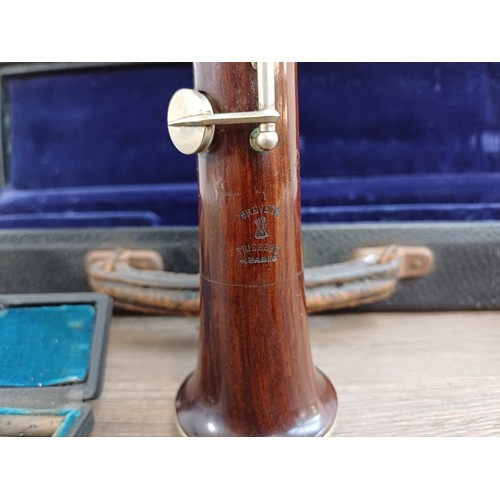 784 - A cased early 20th century French Triébert oboe with cased reeds