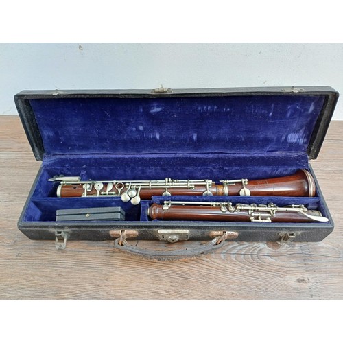 784 - A cased early 20th century French Triébert oboe with cased reeds