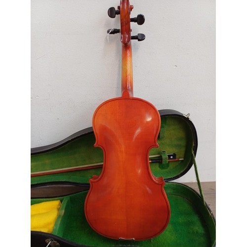 793 - A cased Hsinghai full size violin with bow, shoulder rest and rosin