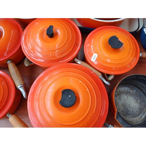 847 - A large collection of enamelled cast iron cookware to include Cousances, Le Creuset and Nacco