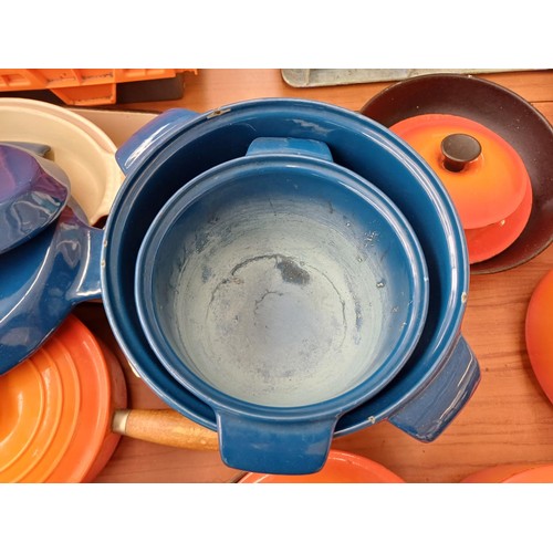 847 - A large collection of enamelled cast iron cookware to include Cousances, Le Creuset and Nacco