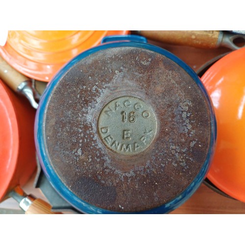 847 - A large collection of enamelled cast iron cookware to include Cousances, Le Creuset and Nacco