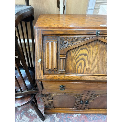 70 - A carved oak bureau - approx. 101cm high x 79cm wide x 44cm deep