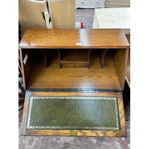 70 - A carved oak bureau - approx. 101cm high x 79cm wide x 44cm deep