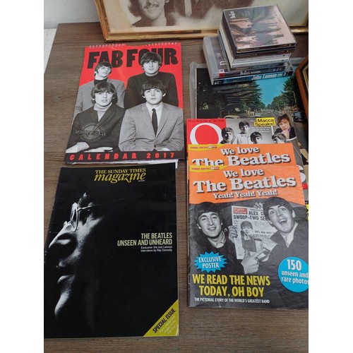 737 - A collection of The Beatles memorabilia and media to include framed print, Abbey Road LP, books, DVD... 