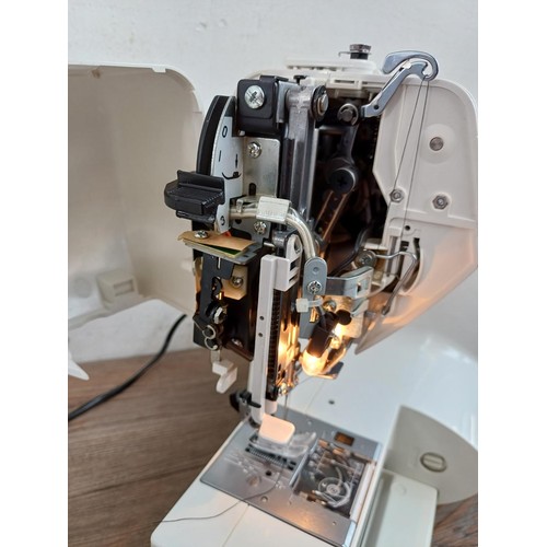 827 - A cased Elma 5300 fifty stitch electric sewing machine with foot pedal and power cable