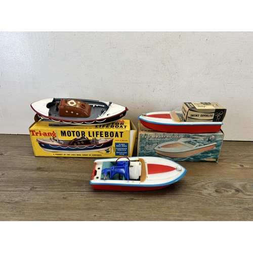 484 - Three vintage model boats, one boxed Tri-ang 401S lifeboat, one Clifford series R3314 cruiser and on... 