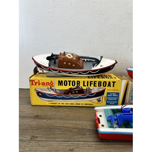 484 - Three vintage model boats, one boxed Tri-ang 401S lifeboat, one Clifford series R3314 cruiser and on... 