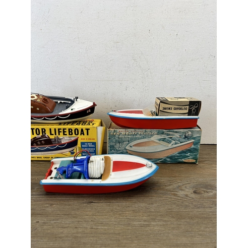 484 - Three vintage model boats, one boxed Tri-ang 401S lifeboat, one Clifford series R3314 cruiser and on... 