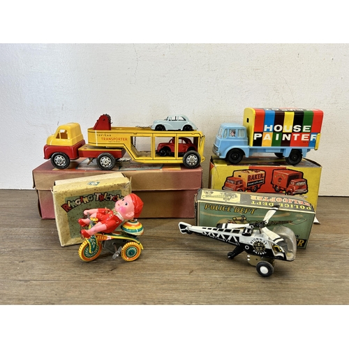 486 - Four vintage boxed tin plate model vehicles, one A Codeg Production ringing tricycle, one friction P... 