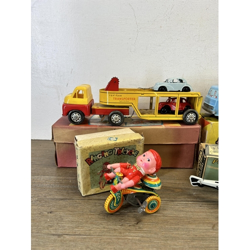 486 - Four vintage boxed tin plate model vehicles, one A Codeg Production ringing tricycle, one friction P... 