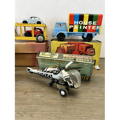 486 - Four vintage boxed tin plate model vehicles, one A Codeg Production ringing tricycle, one friction P... 