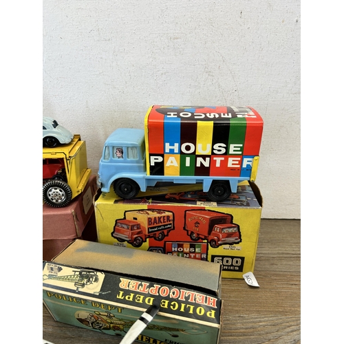 486 - Four vintage boxed tin plate model vehicles, one A Codeg Production ringing tricycle, one friction P... 