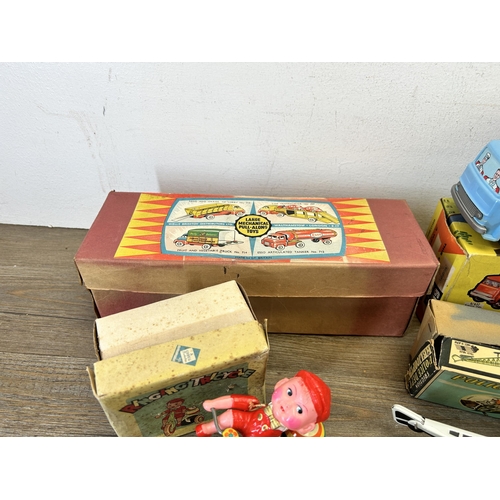 486 - Four vintage boxed tin plate model vehicles, one A Codeg Production ringing tricycle, one friction P... 