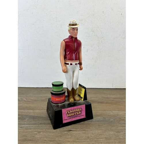 493 - A vintage Paladone personal shopper talking figurine