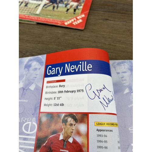 572 - A collection of 1990s Manchester United official programmes together with a signed official year boo... 