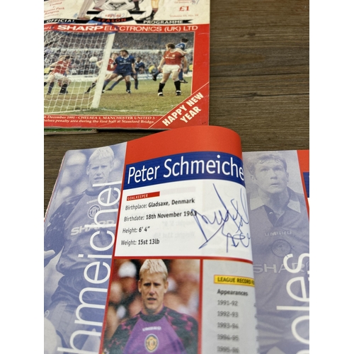 572 - A collection of 1990s Manchester United official programmes together with a signed official year boo... 