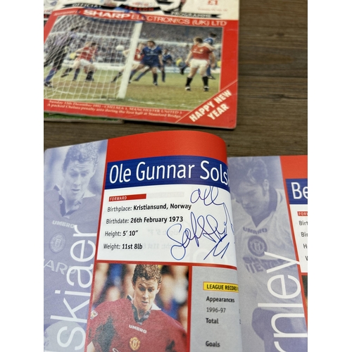 572 - A collection of 1990s Manchester United official programmes together with a signed official year boo... 