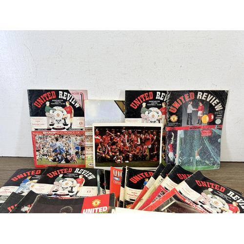 572 - A collection of 1990s Manchester United official programmes together with a signed official year boo... 