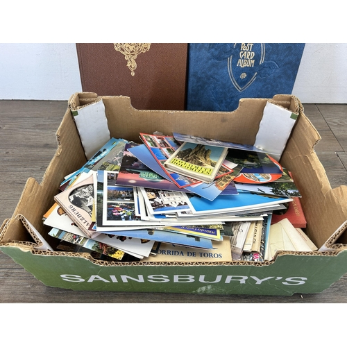 582 - A large collection of vintage and later scrapbooks containing vintage postcards