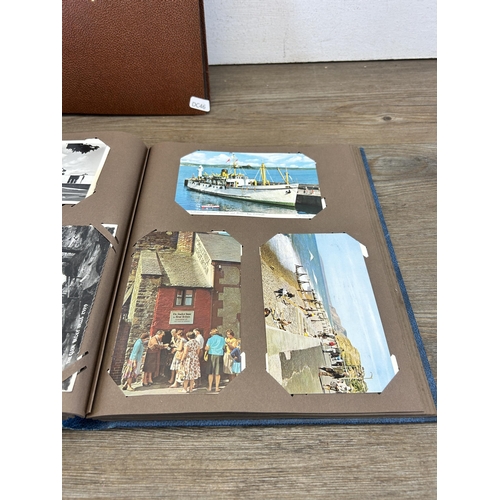 582 - A large collection of vintage and later scrapbooks containing vintage postcards