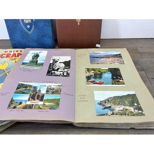 582 - A large collection of vintage and later scrapbooks containing vintage postcards