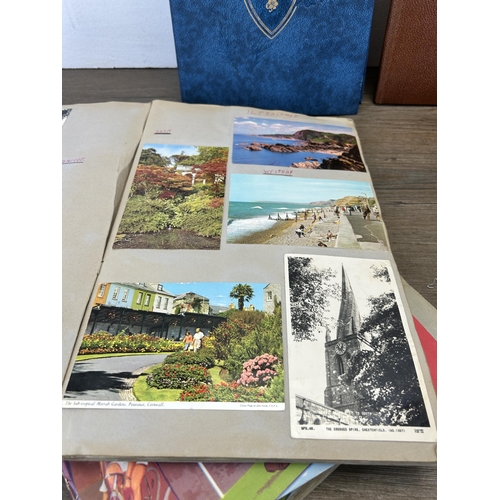 582 - A large collection of vintage and later scrapbooks containing vintage postcards