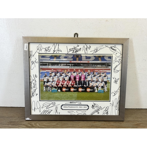 584 - A framed and signed Bolton Wanderers F.C. 2011-2012 photograph - approx. 32cm high x 42cm wide