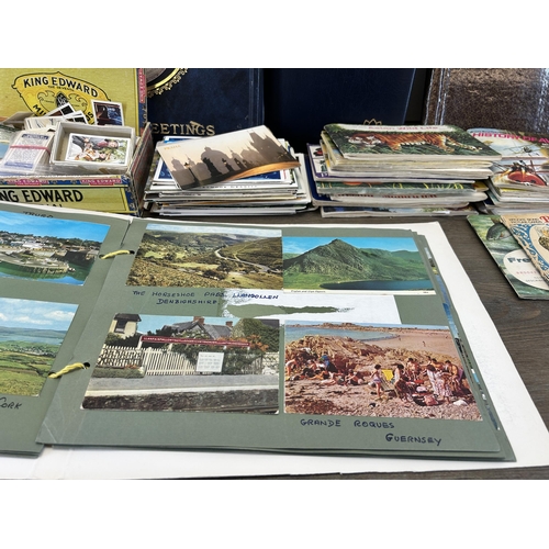 587 - A large collection of vintage postcards and picture cards together with four Victorian portrait phot... 