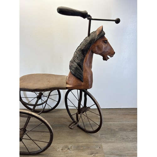 641 - An early/mid 20th century French carved hardwood and metal pedal horse tricycle/velocipede - approx.... 