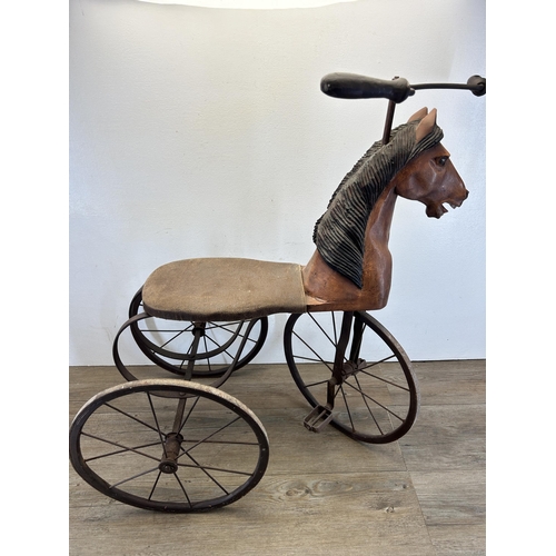 641 - An early/mid 20th century French carved hardwood and metal pedal horse tricycle/velocipede - approx.... 