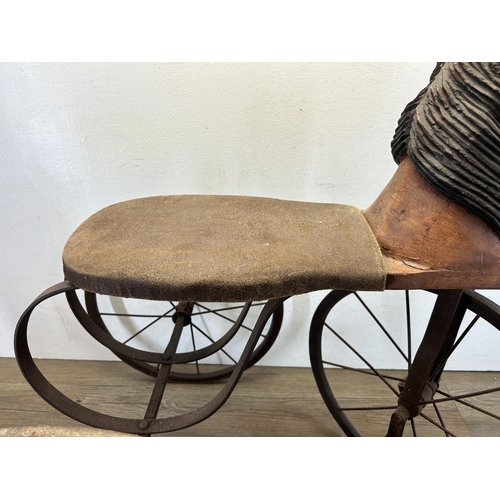 641 - An early/mid 20th century French carved hardwood and metal pedal horse tricycle/velocipede - approx.... 