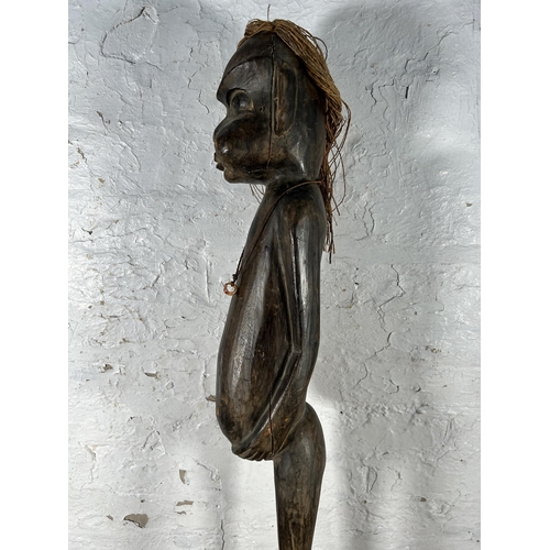 648 - A Maori carved hardwood statue - approx. 98cm high