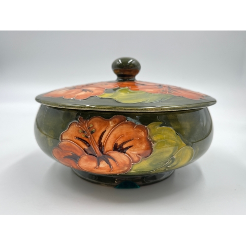 299 - A Moorcroft Coral Hibiscus pattern circular lidded trinket box - approx. 14cm diameter