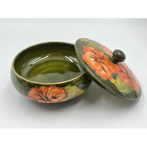 299 - A Moorcroft Coral Hibiscus pattern circular lidded trinket box - approx. 14cm diameter