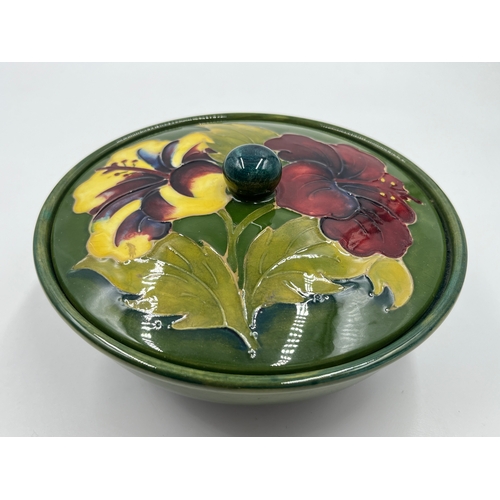 302 - A Moorcroft Hibiscus pattern circular lidded trinket box - approx. 16cm diameter