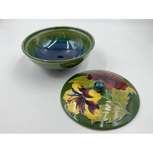 302 - A Moorcroft Hibiscus pattern circular lidded trinket box - approx. 16cm diameter