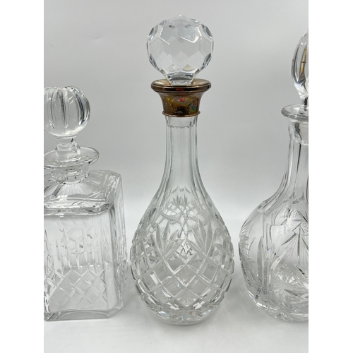 320 - Three cut glass decanters to include Edinburgh Crystal, hallmarked Birmingham silver collared etc. -... 