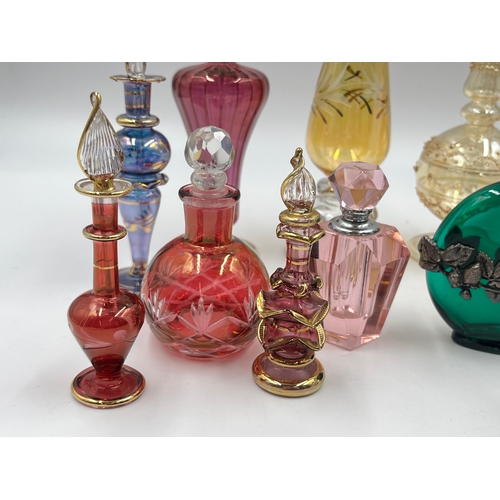 325 - Twelve glass scent bottles - largest approx. 23cm high