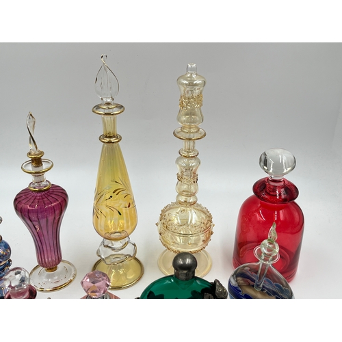 325 - Twelve glass scent bottles - largest approx. 23cm high