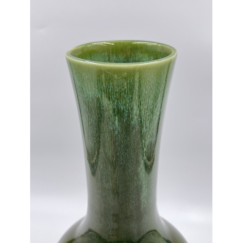 330 - A mid 20th century green drip glazed studio pottery vase, stamped DC10 - approx. 31cm high