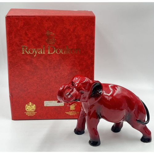 336 - A boxed Royal Doulton Flambé Elephant with Trunk Raised in Salute figurine - model no. 489A