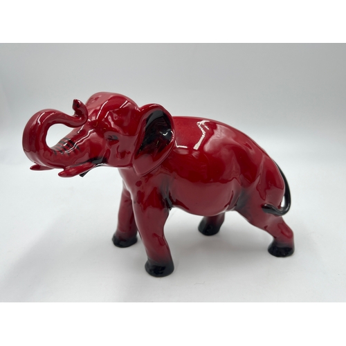 336 - A boxed Royal Doulton Flambé Elephant with Trunk Raised in Salute figurine - model no. 489A