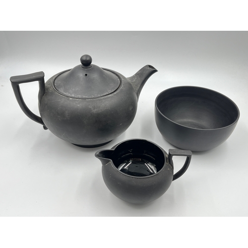 338 - A Wedgwood black basalt three piece tea set