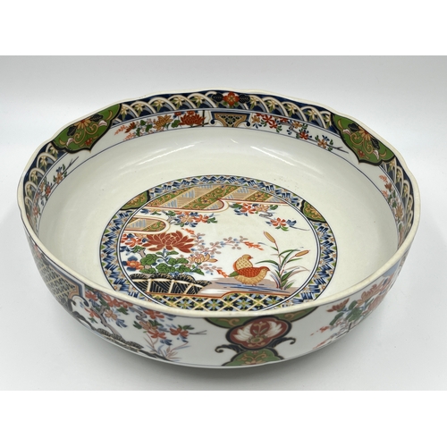 347 - A Japanese porcelain circular footed bowl - approx. 27cm diameter